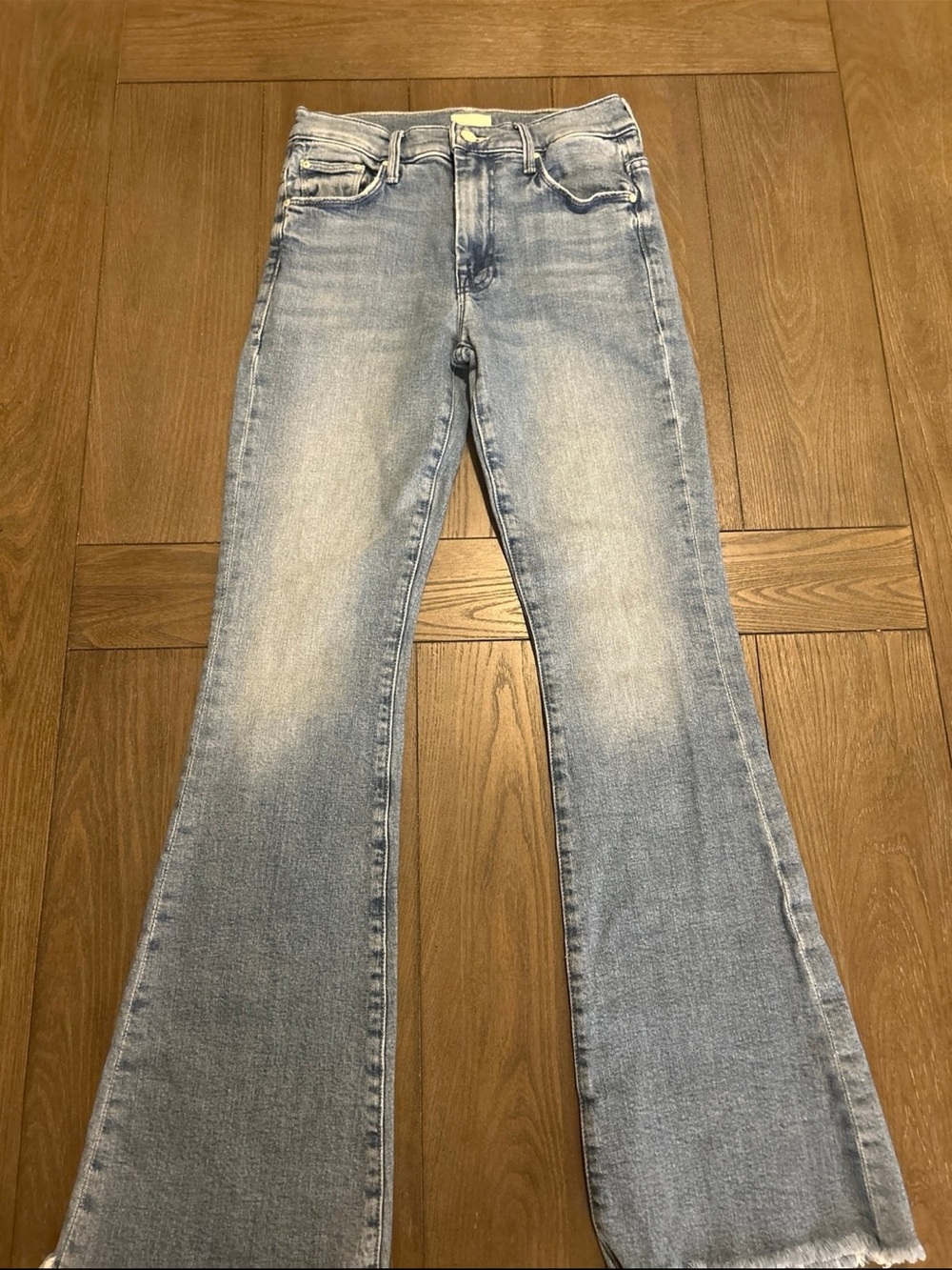 MOTHER Light Wash Flare Jeans in Faded Blue